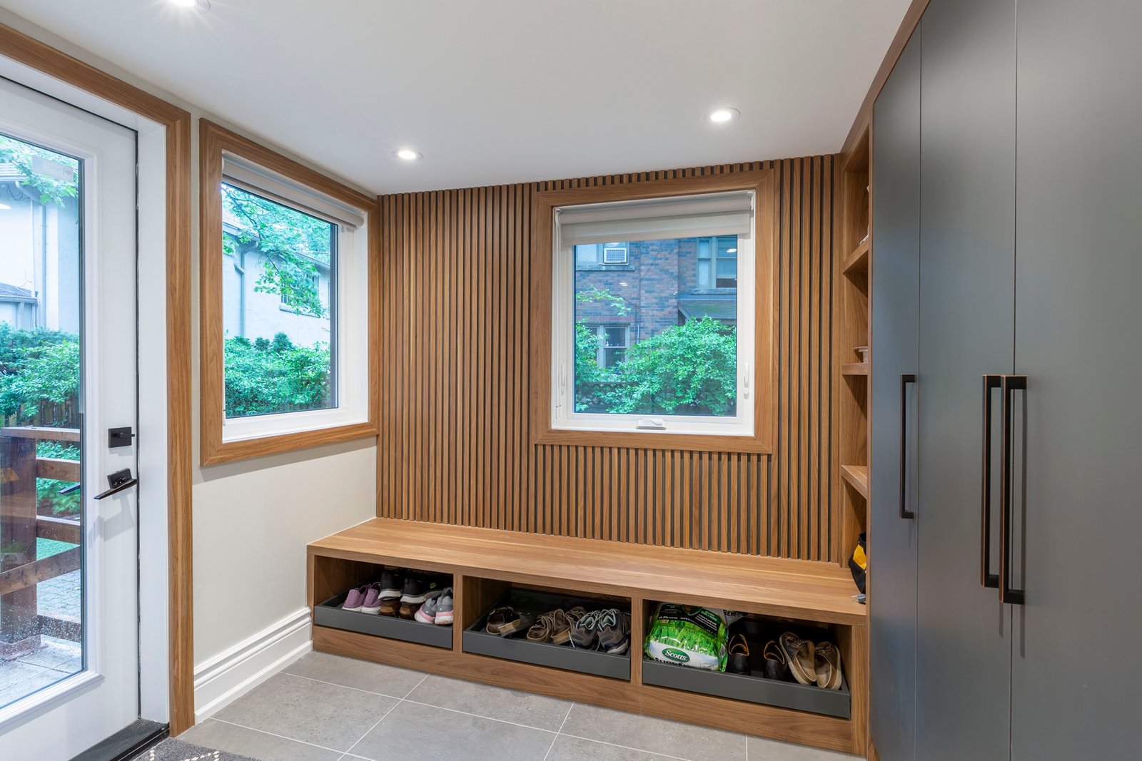 Mudroom with wood slat wall and built in bench