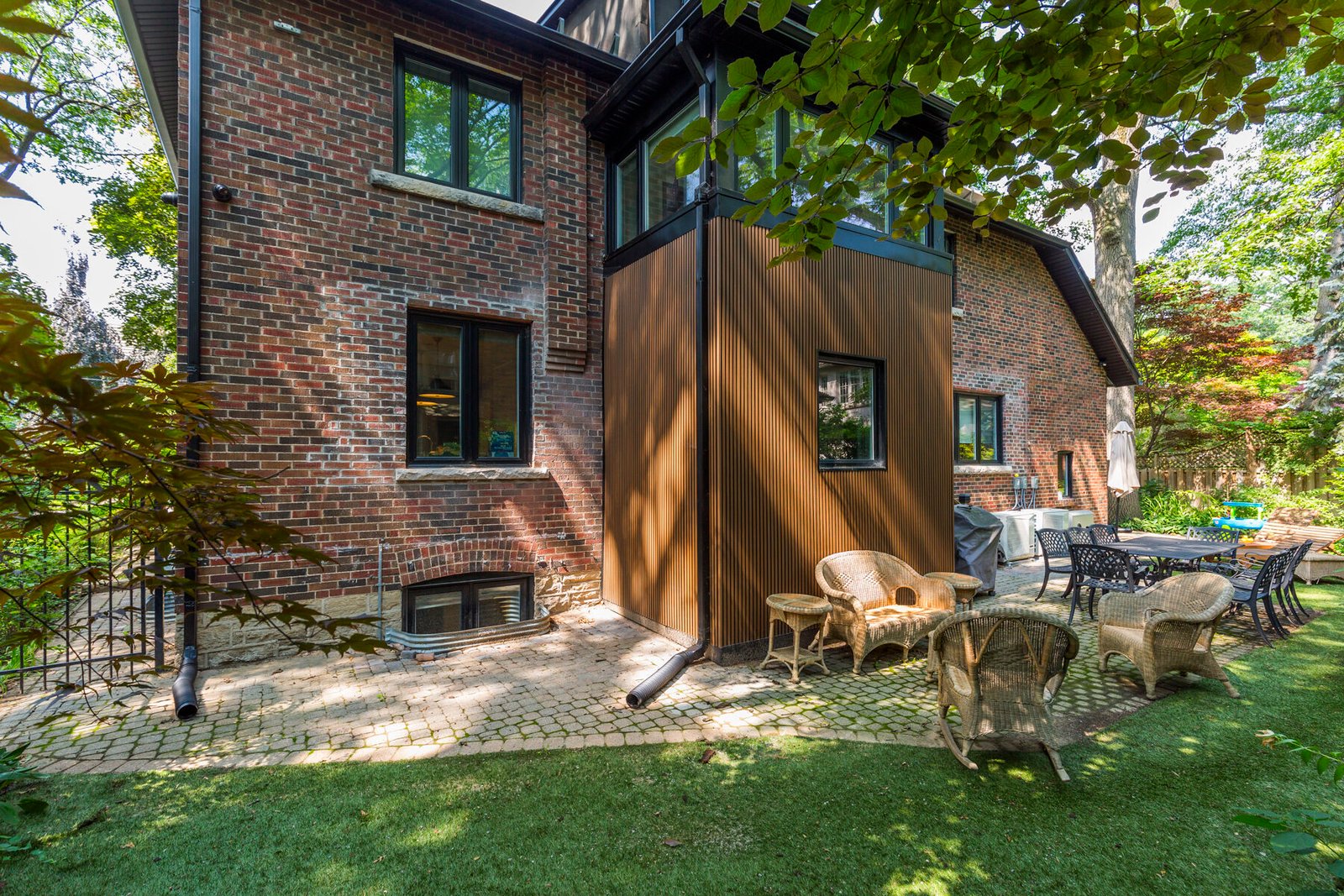 Rear addition with wood siding on brick home