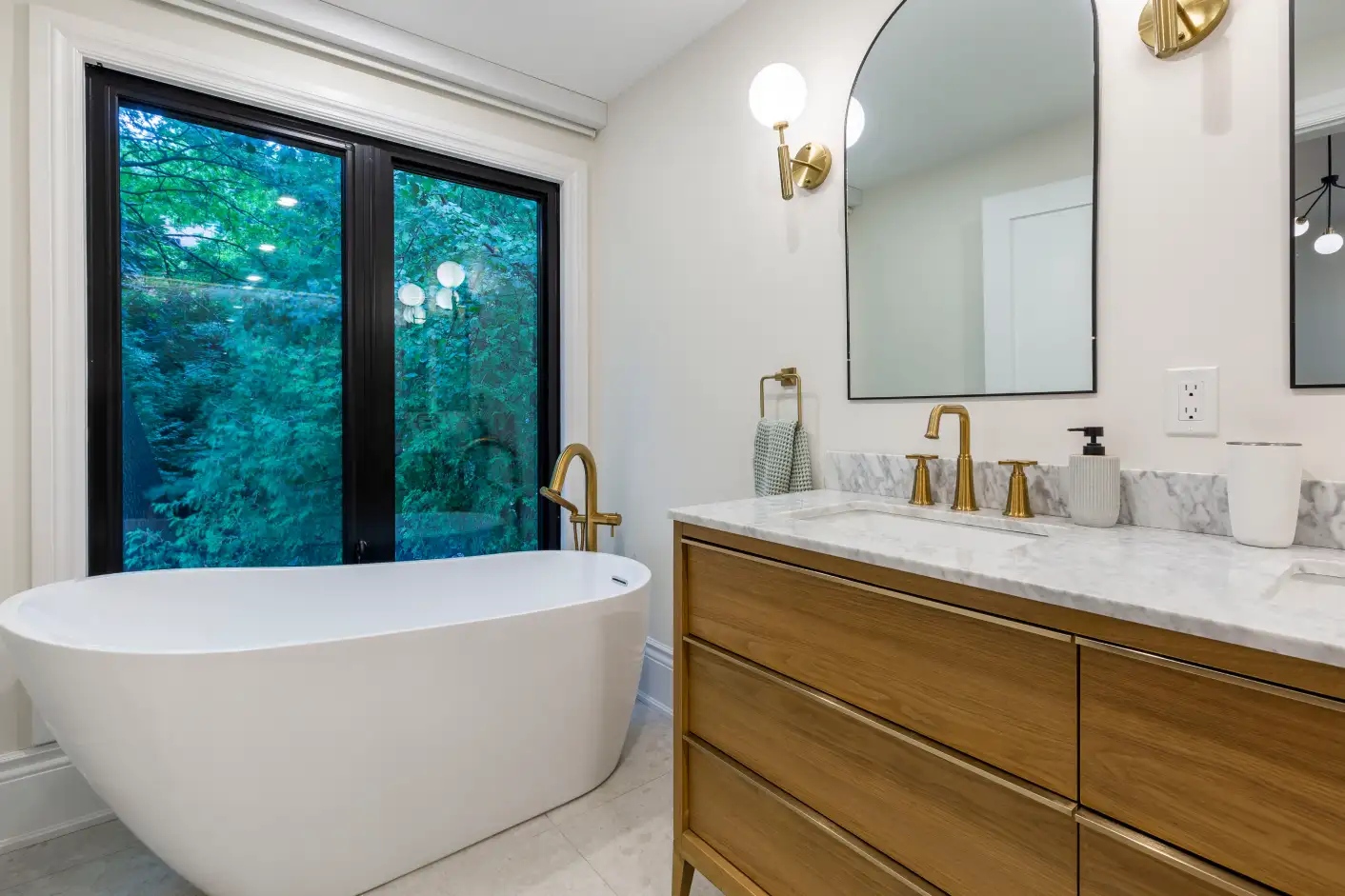 Bathroom with freestanding tub and double wood vanity