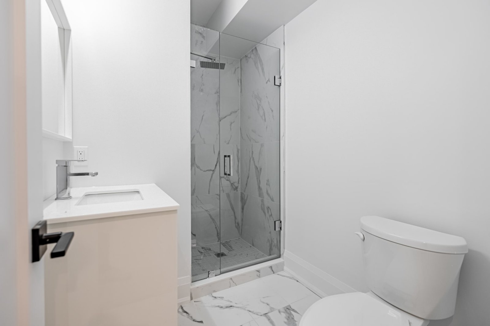 Bathroom with marble tile and glass shower