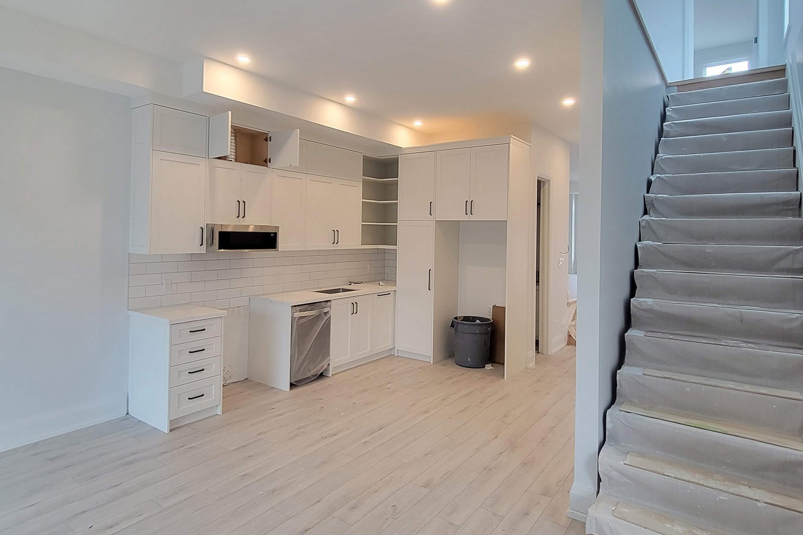 Main floor cabinetry and staircase during finishing