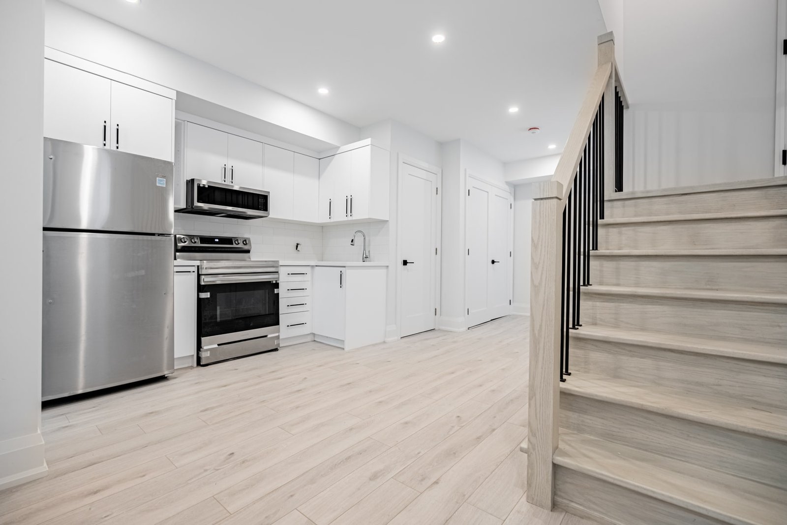 White kitchen with stainless steel appliances
