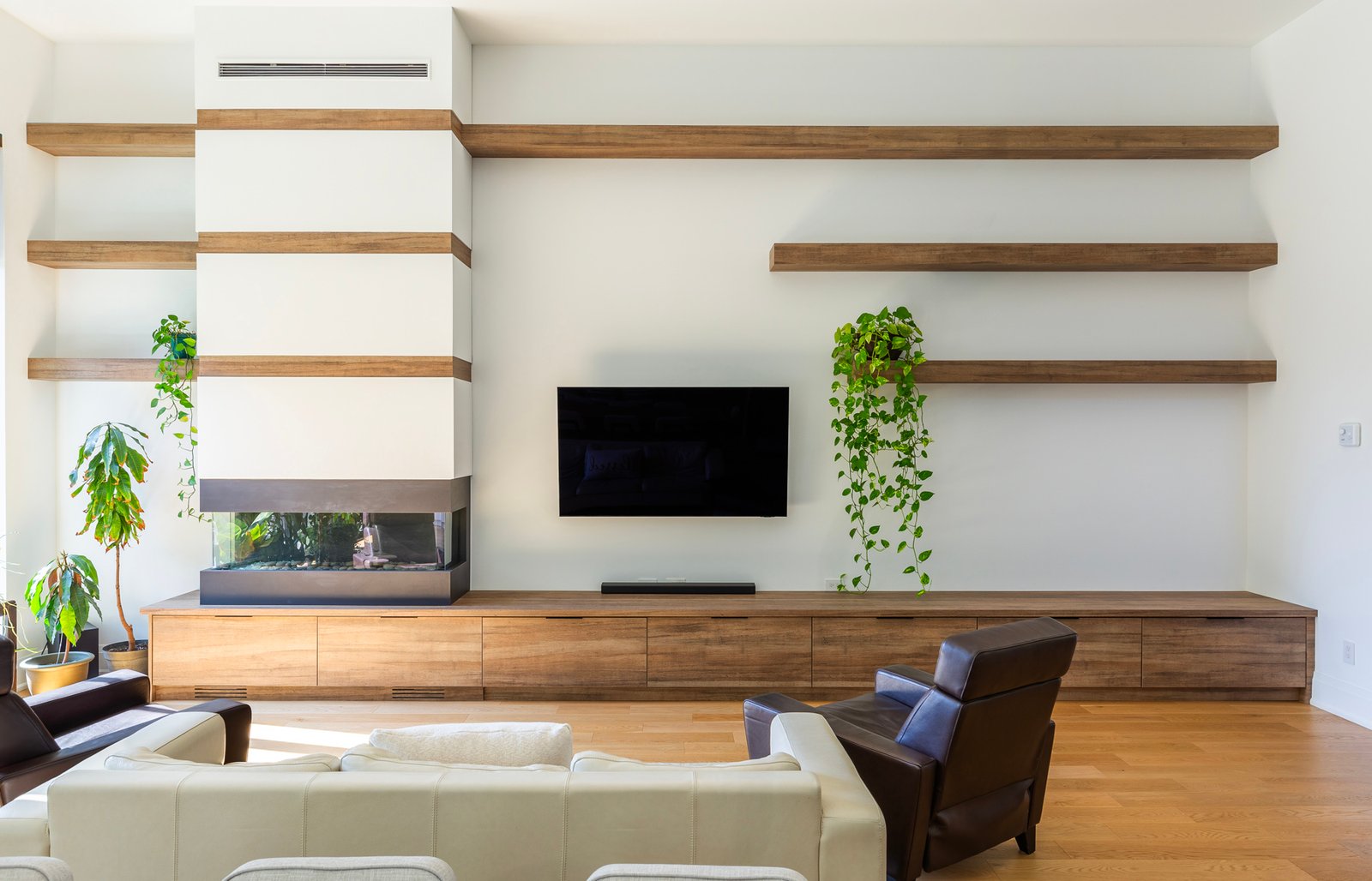 Living room media wall with floating wood shelves