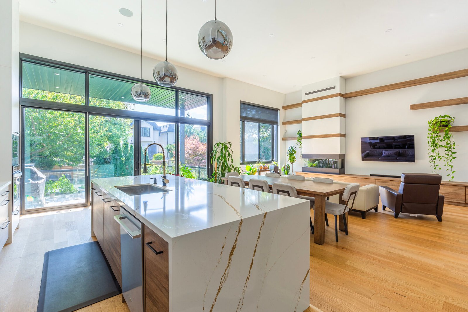 Open concept kitchen and dining with full height windows