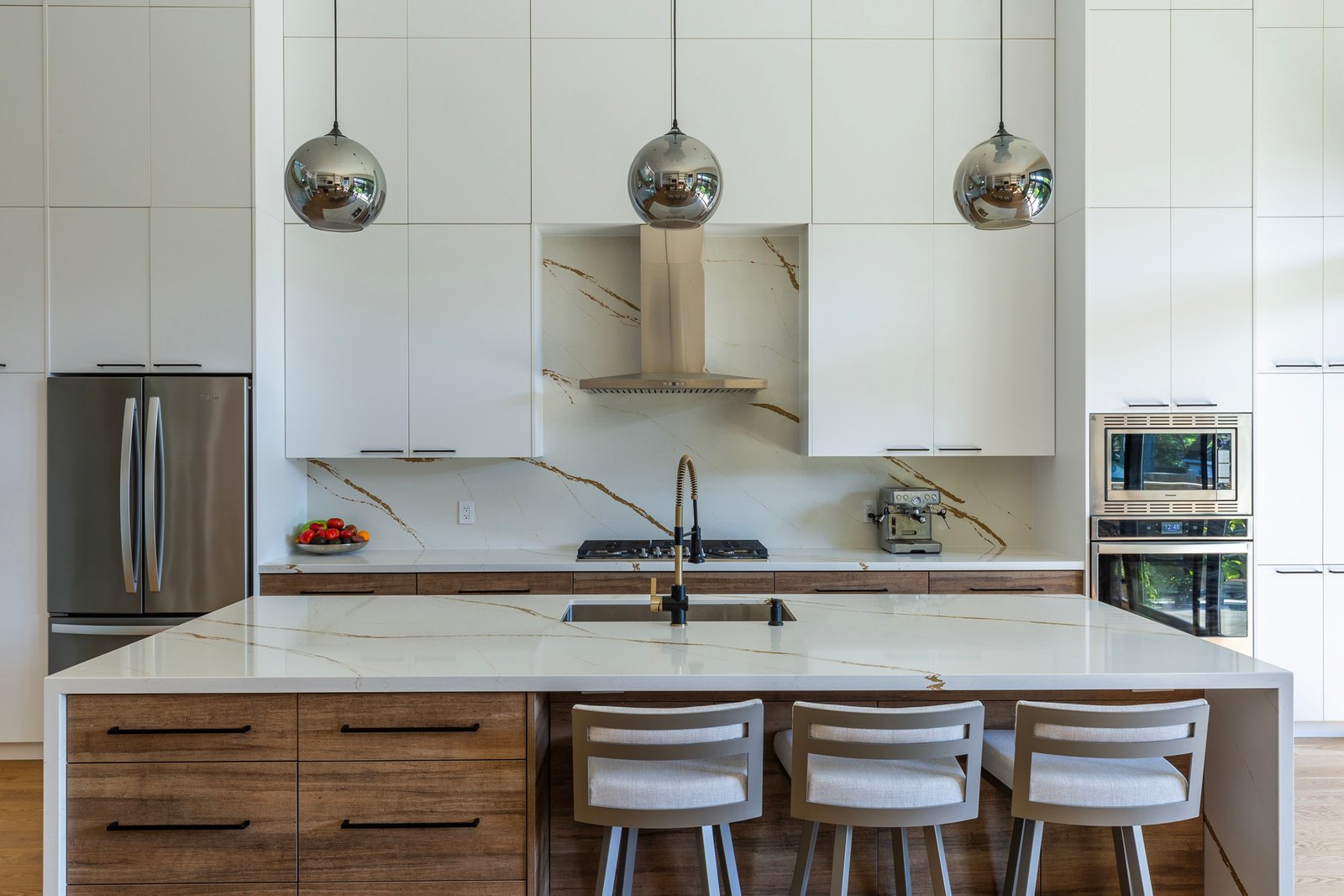 White kitchen with marble waterfall island