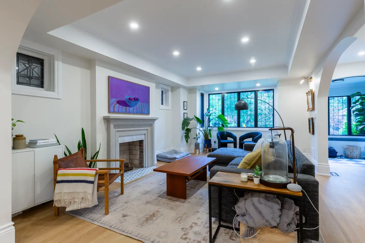 Bright living room with fireplace and large front windows