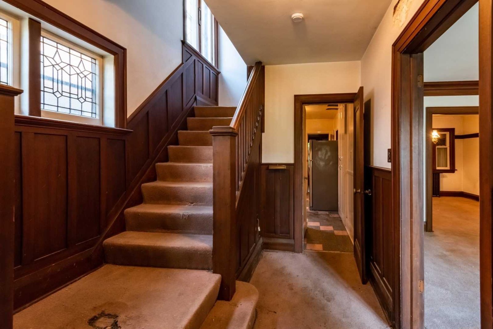 Original dark wood staircase before the renovation