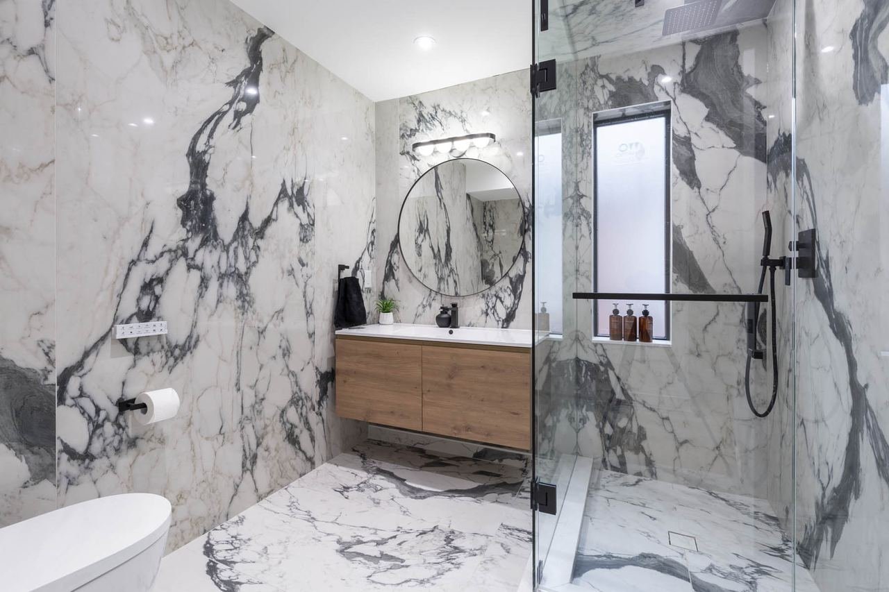 Bathroom with black and white marble and glass shower