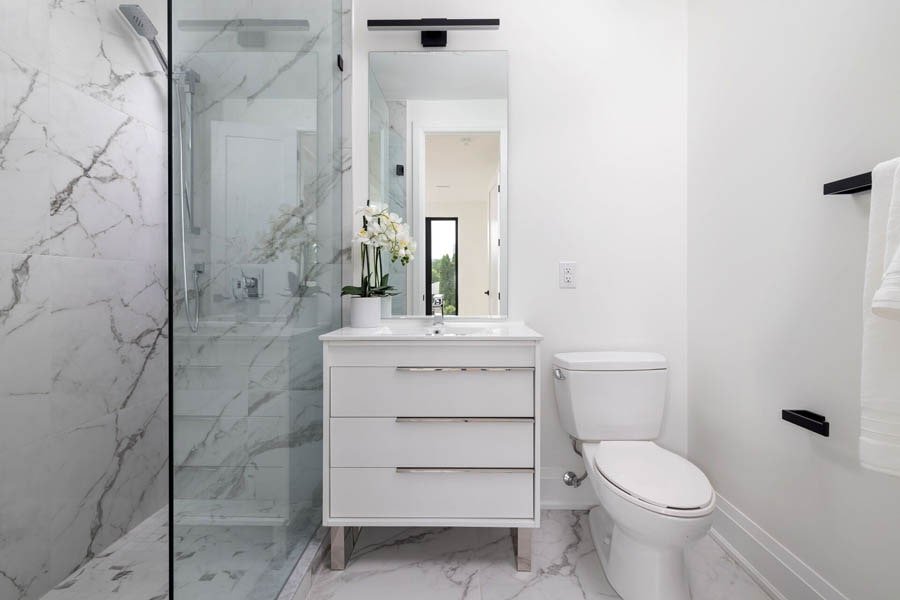 Bathroom with marble tile and glass shower