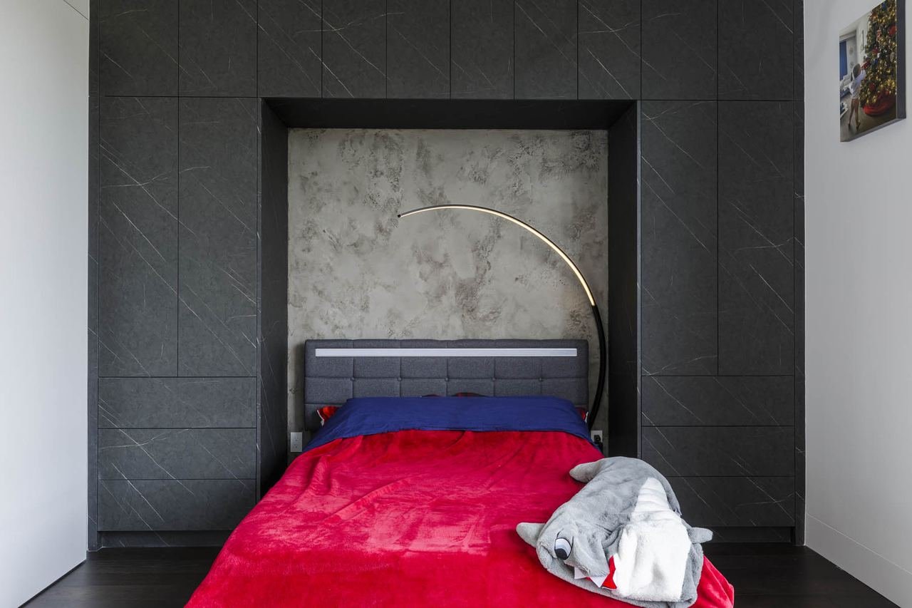 Bedroom with dark stone feature wall