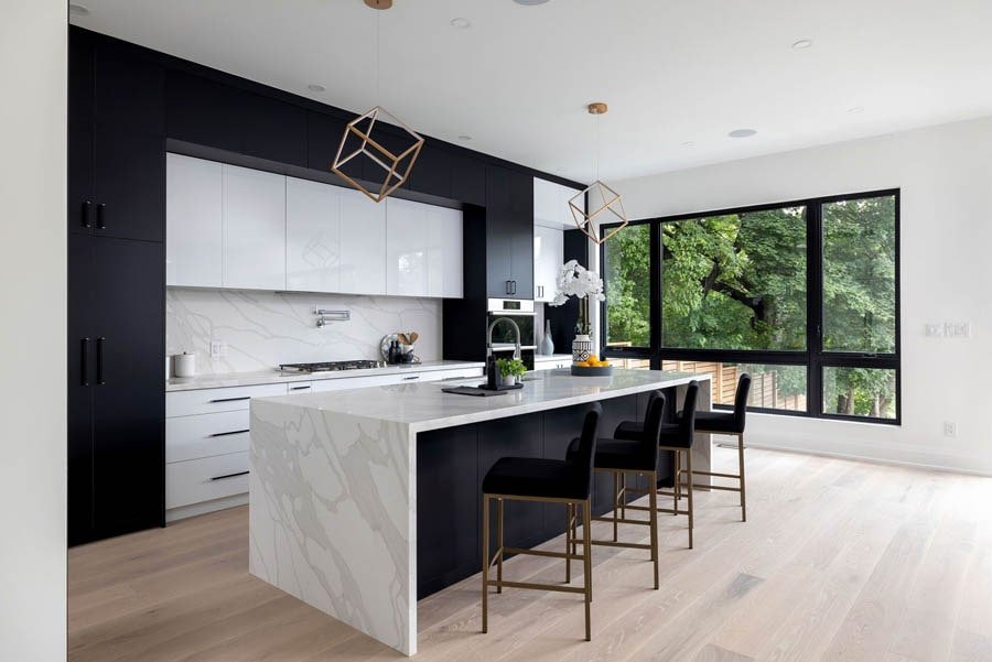 Black and white kitchen with waterfall island and bar seating