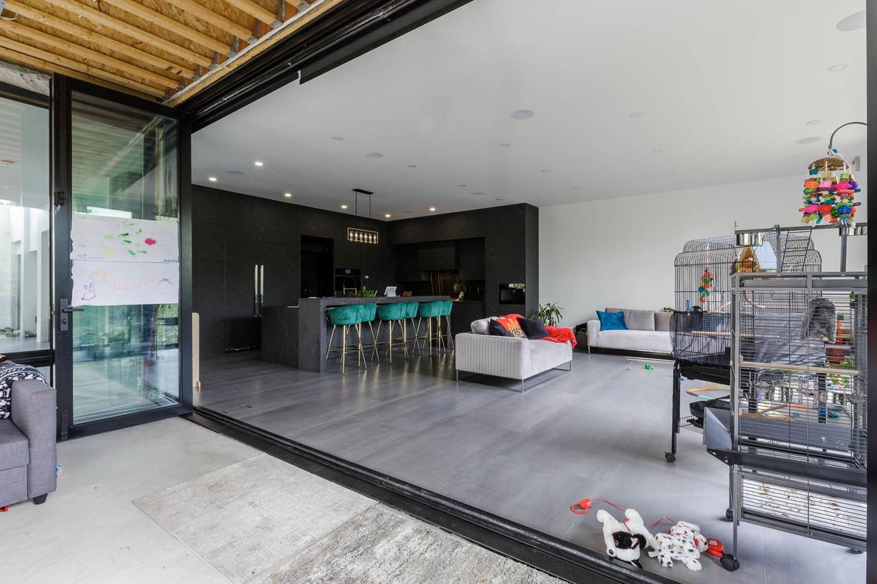 Covered patio with open full-width sliding doors into kitchen