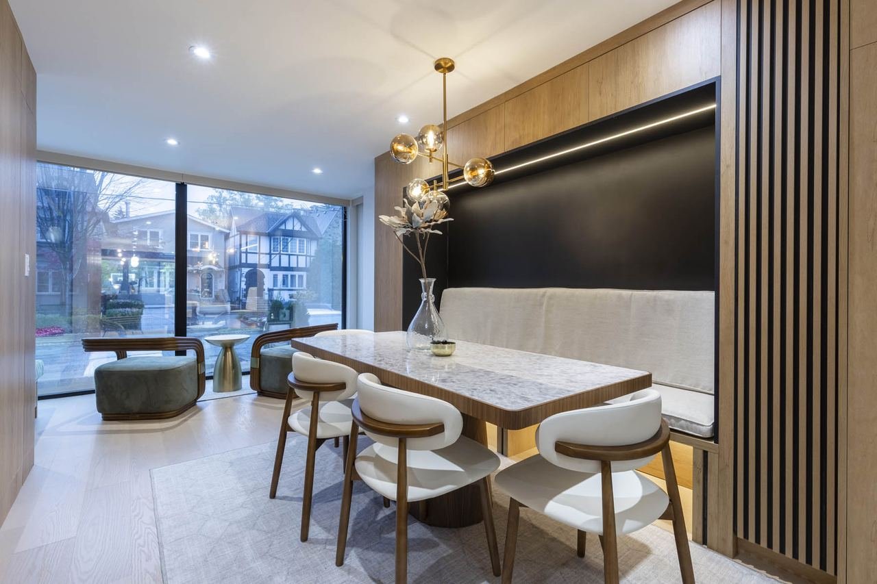 Dining nook with custom wood panelling and banquette seating