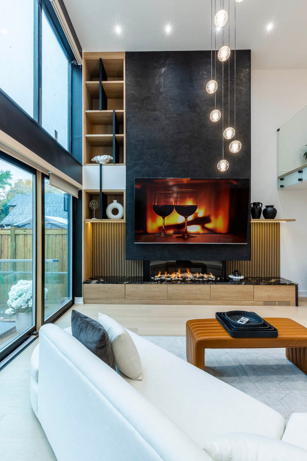 Lounge with black feature wall and linear fireplace