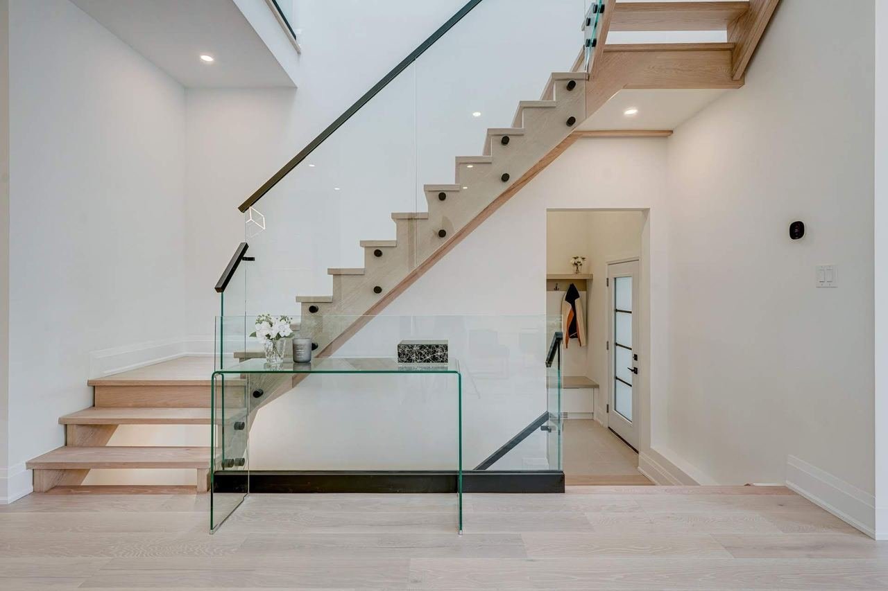 Floating stairs with glass railing and open main floor