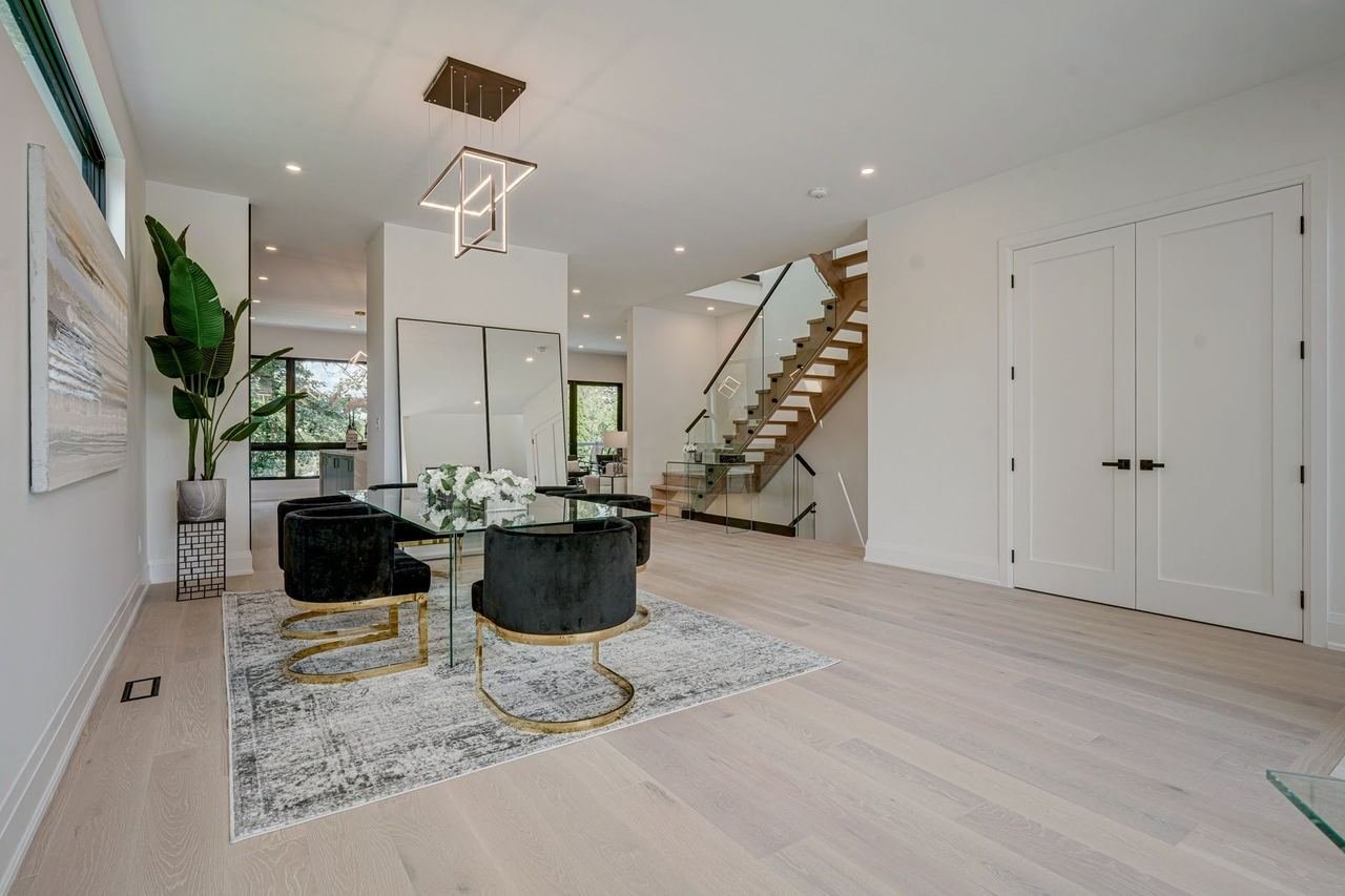Foyer and fully open main floor with staircase