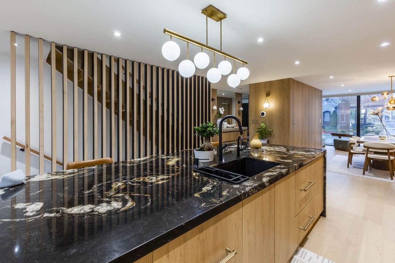 Kitchen island with globe pendants and wood slat screen