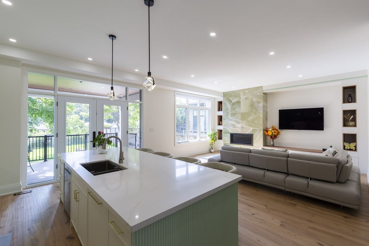 Kitchen island with view to living room and onyx media wall
