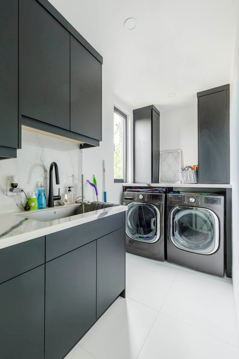 Laundry room with black cabinetry
