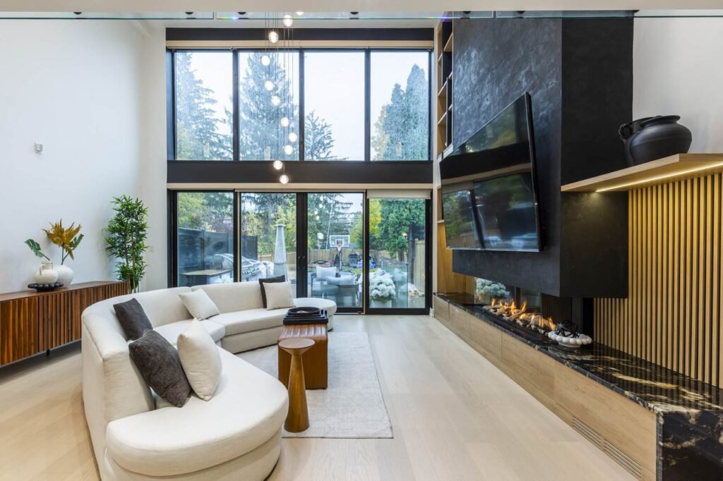 Living room with black media wall and linear fireplace