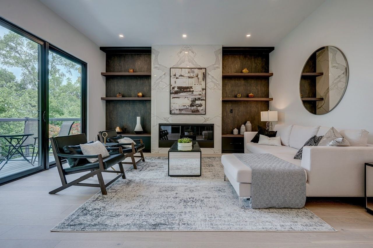 Living room with sectional and black media wall shelving