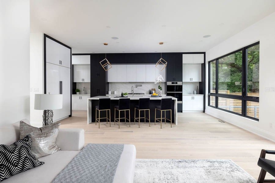 Open concept kitchen and living space with black and white finishes
