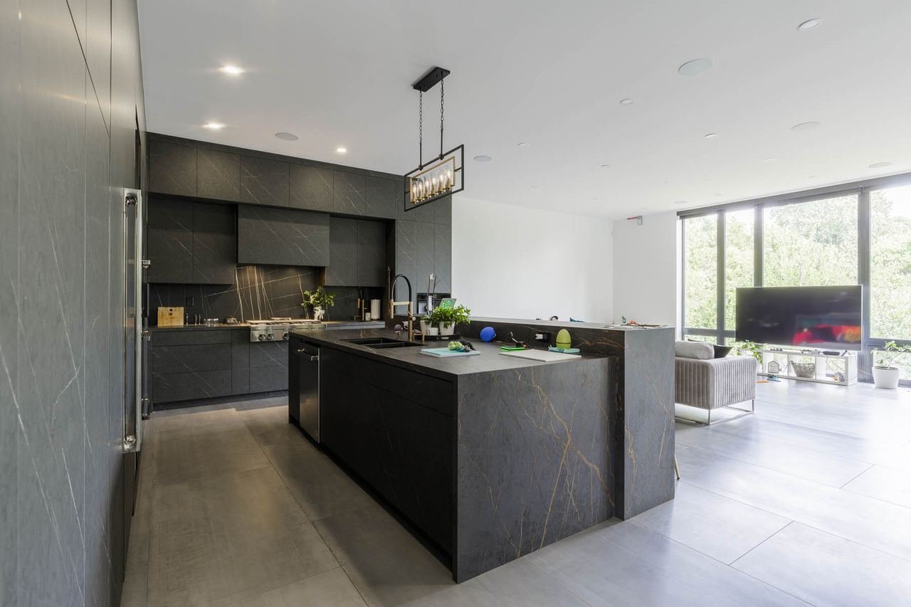 Open concept kitchen with view to L-shaped living and dining space