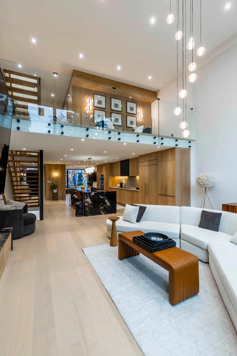 Open-to-above lounge with mezzanine and pendant lighting