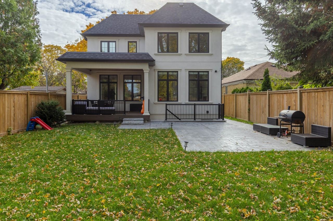 Rear elevation with backyard lawn and landscaping — 54 Savona Drive