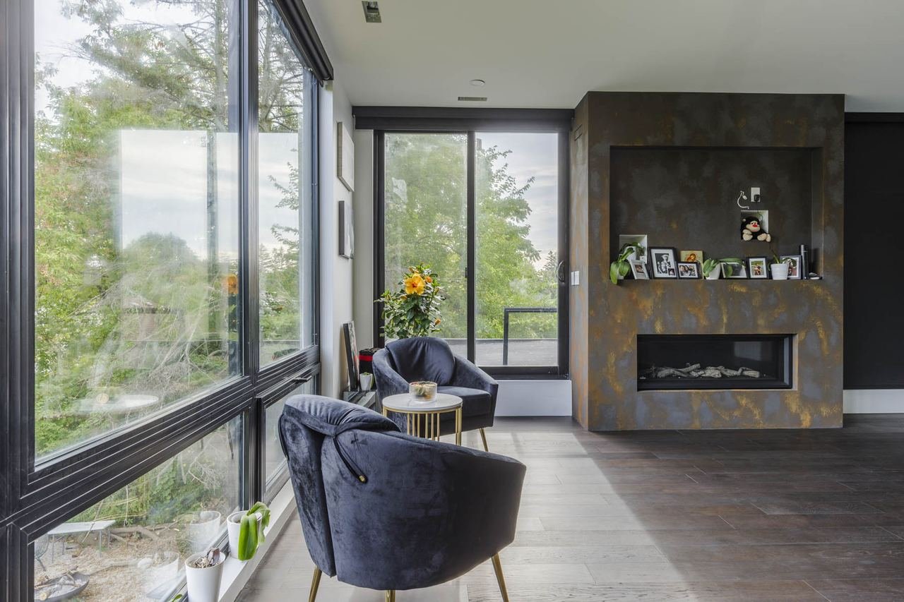 Sitting area with fireplace and floor-to-ceiling windows