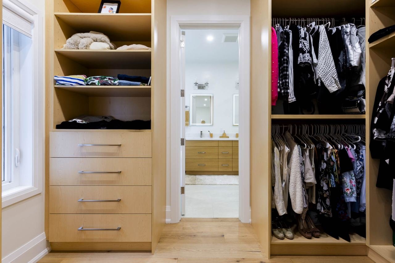 Walk-in closet with custom organizers and ensuite view