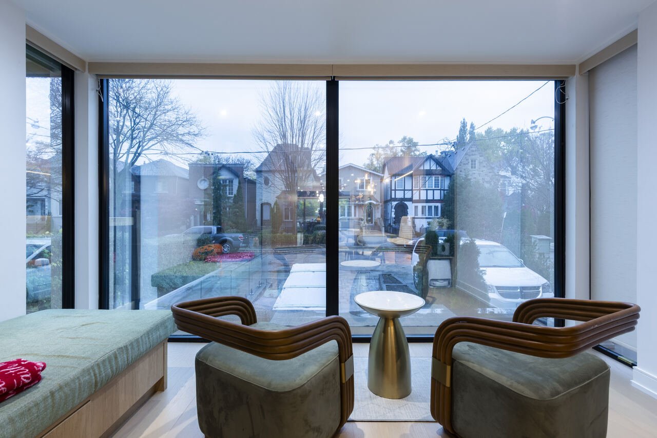 Front sitting nook with built-in bench and floor-to-ceiling windows facing the street
