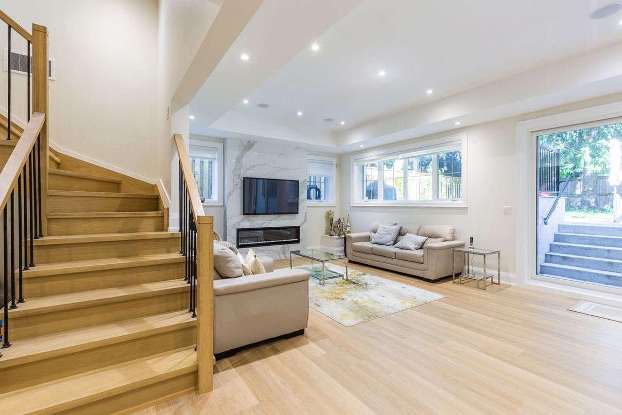 Basement rec room with oak stairs and walkout to the backyard