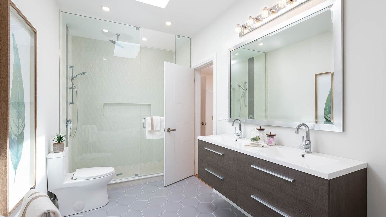 Bathroom with glass shower and double vanity