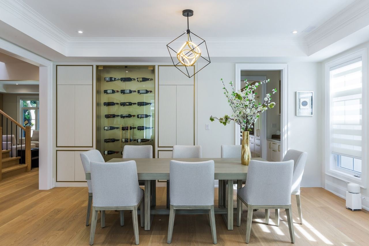 Dining table with fluted cabinetry and backlit wine display