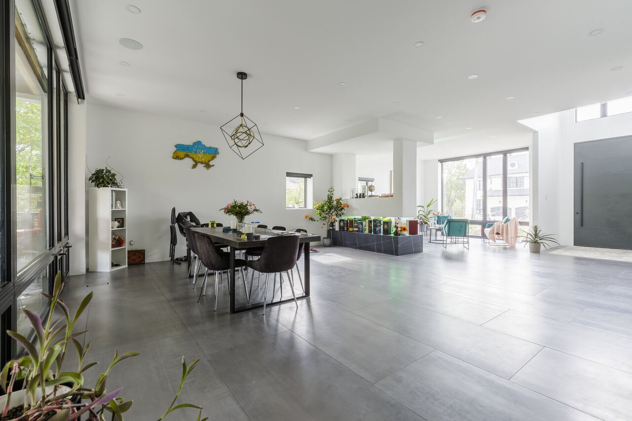 Open concept dining and living area with oversized porcelain floor tile