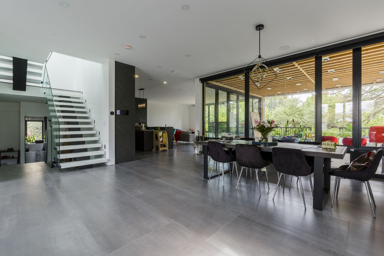 Dining area open to the kitchen with sliding doors to the cedar pergola