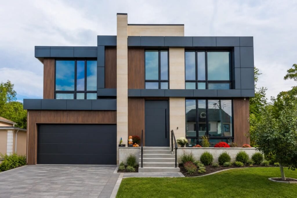 Front elevation of the completed Donnavale custom home with dark panel cladding, wood slats and double garage