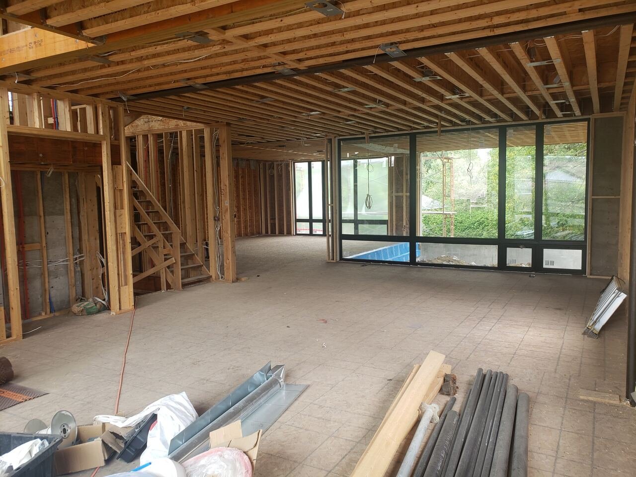 Main floor at framing stage with new black-framed windows installed