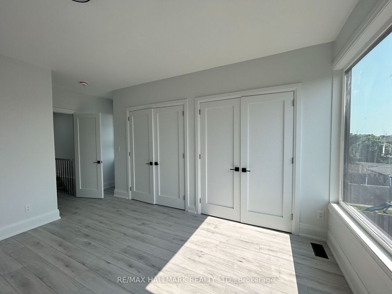 Bedroom with double closets and oversized window
