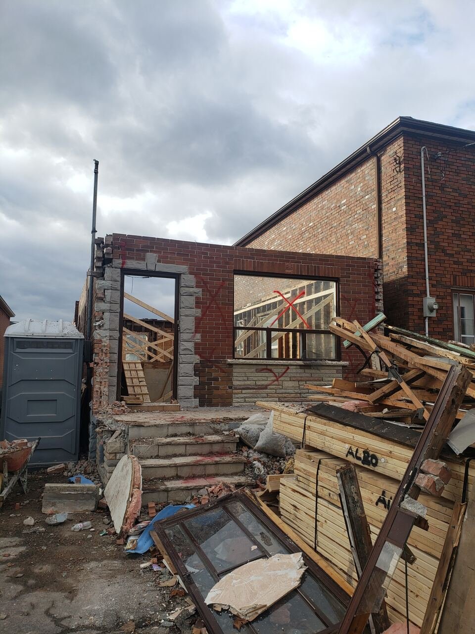 Front of the bungalow during demolition with roof removed