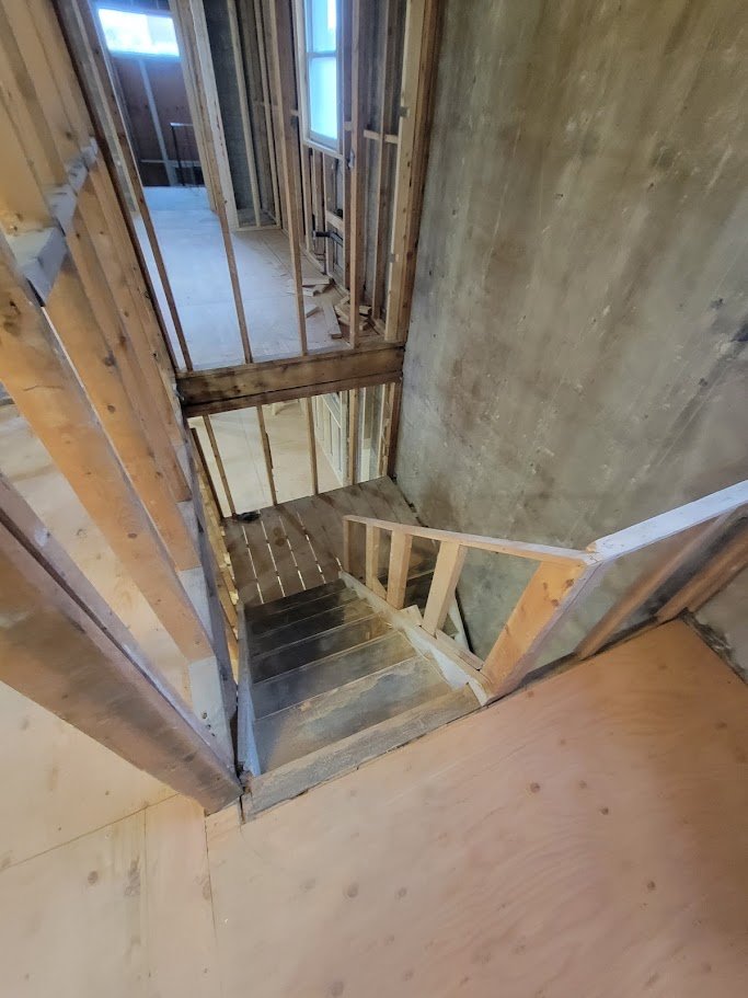 Upper floor with new stud partitions framed and plywood subfloor down