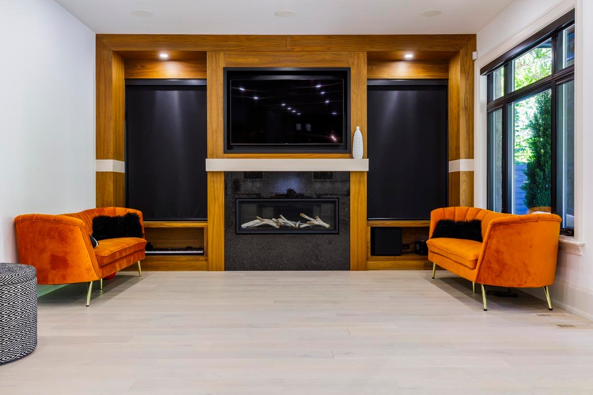 Family room lounge with fireplace, TV and wood feature wall