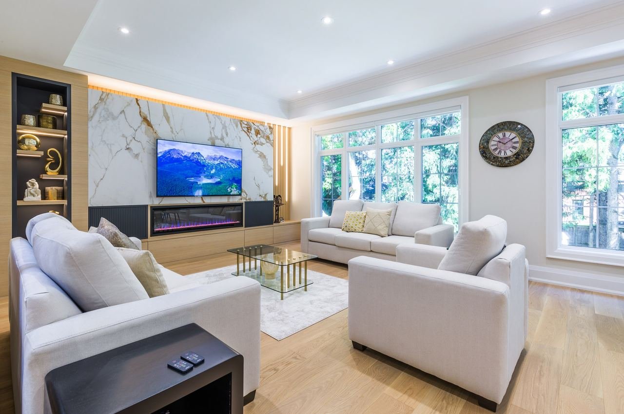 Family room with marble media wall, LED fireplace and oak built-ins