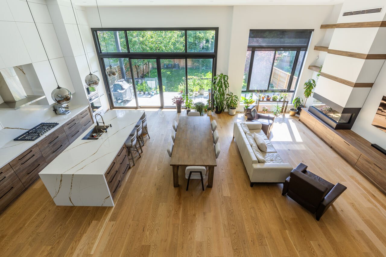 Open concept main floor from above with waterfall island, dining area and living room