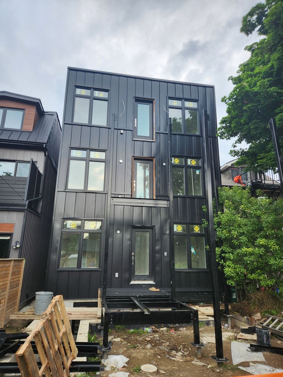 Completed rear elevation with black board and batten cladding and steel stair structure