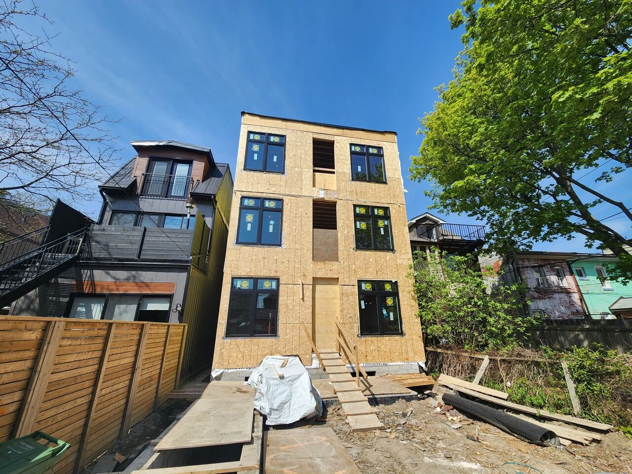 Rear elevation sheathed with new black windows installed