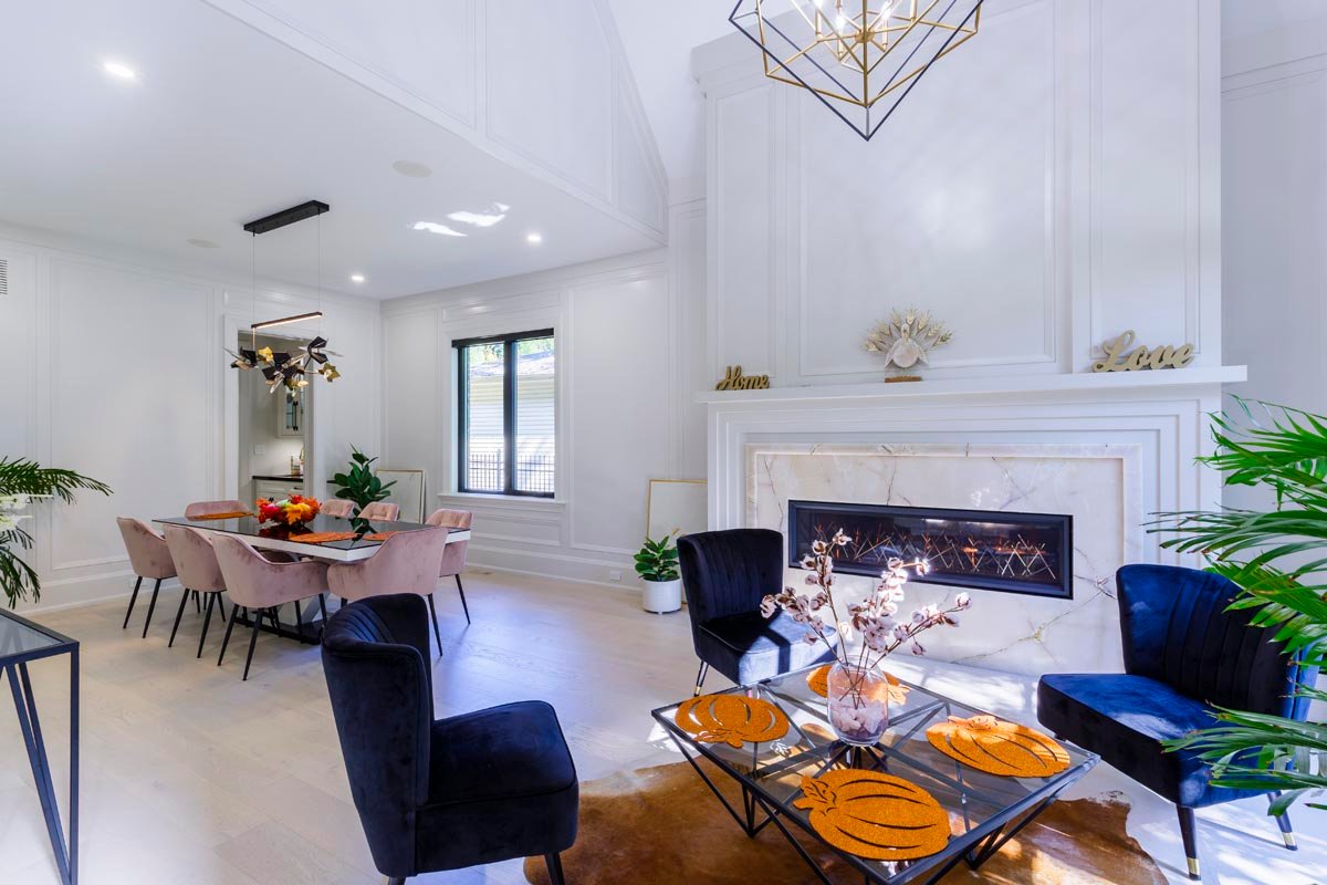 Living and dining space with fireplace and vaulted ceiling