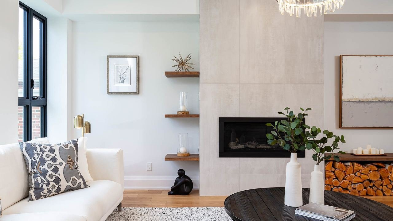 Living room with concrete-panel fireplace wall and firewood niche