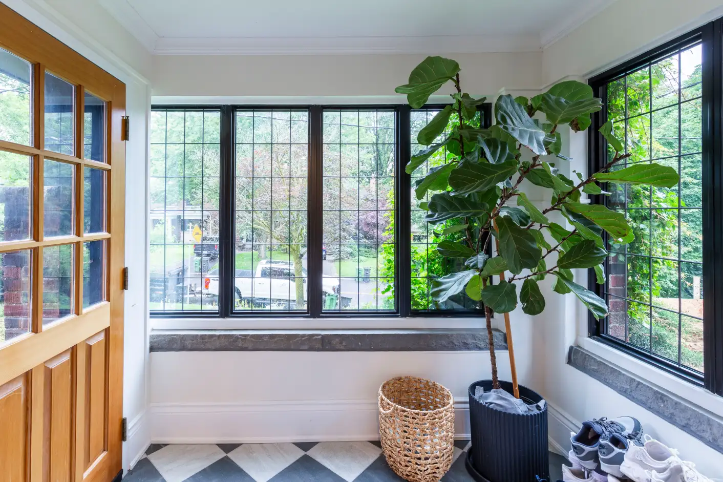 Enclosed front entry porch with leaded glass windows and checkered tile floor